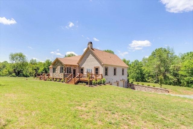 rear view of house featuring a wooden deck and a lawn