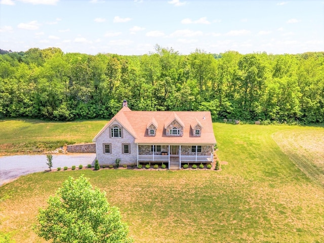 view of front of house featuring covered porch and a front yard