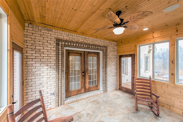 unfurnished sunroom with wood ceiling, french doors, and ceiling fan