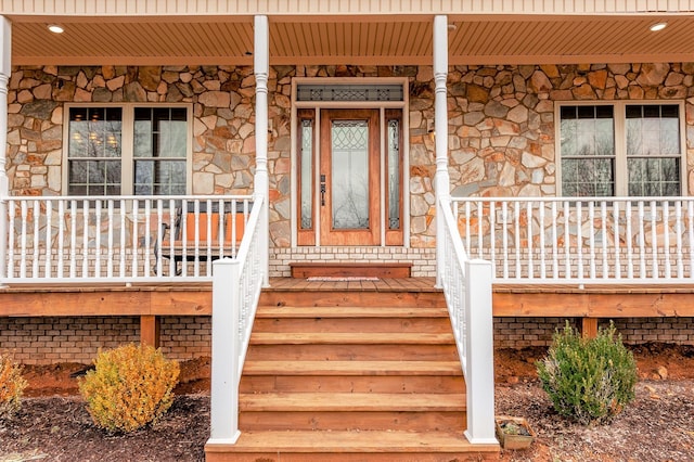 view of exterior entry with covered porch