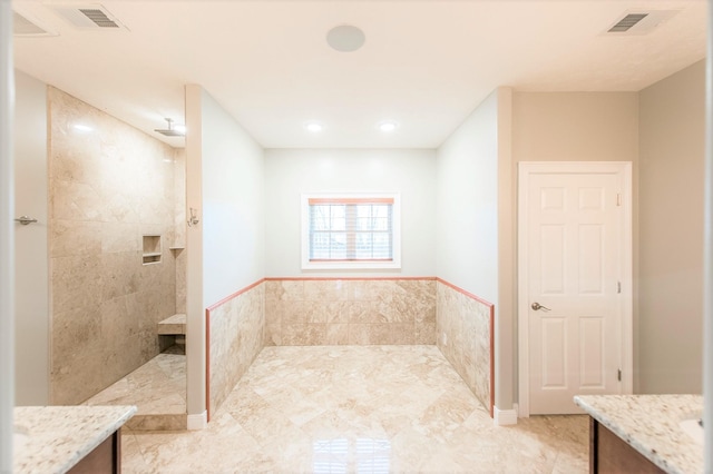 bathroom with walk in shower and vanity