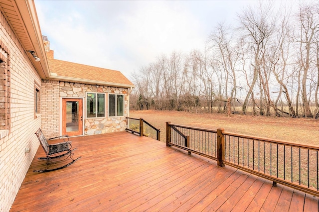 wooden terrace with a lawn