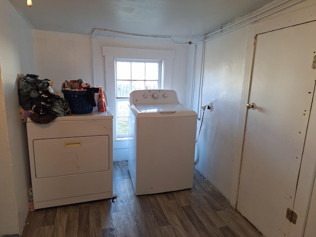 laundry area with dark hardwood / wood-style flooring and washer and clothes dryer