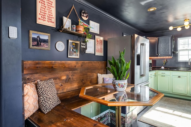 dining space featuring ornamental molding and sink