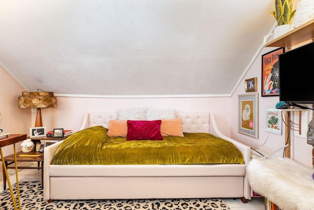 bedroom with vaulted ceiling and a textured ceiling