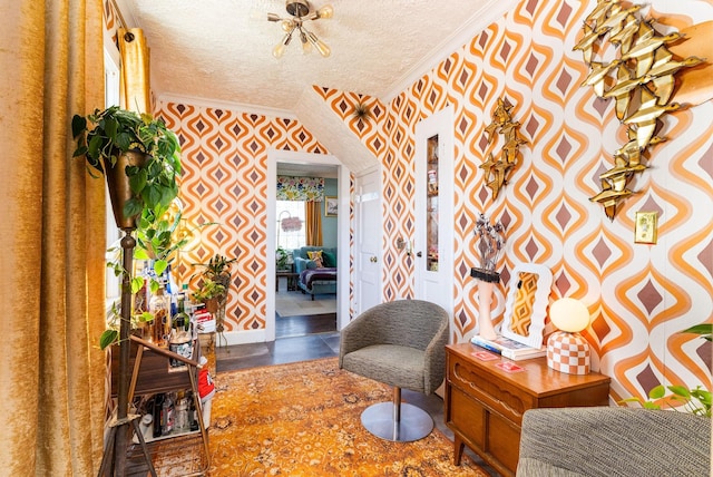 sitting room with ornamental molding and a textured ceiling