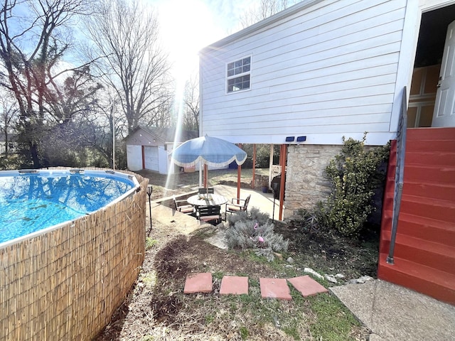 view of swimming pool with a shed