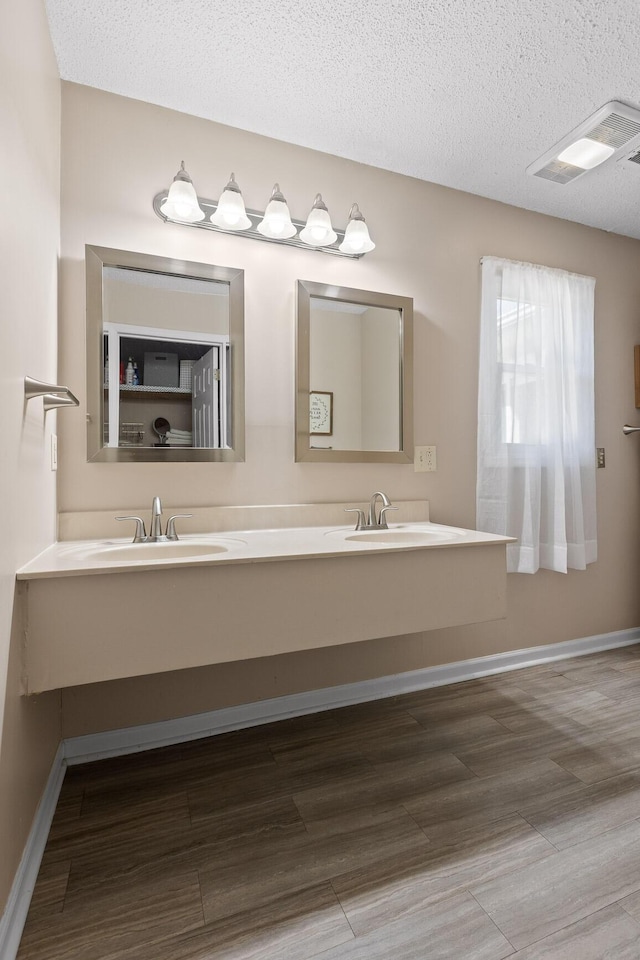 bathroom with vanity and a textured ceiling