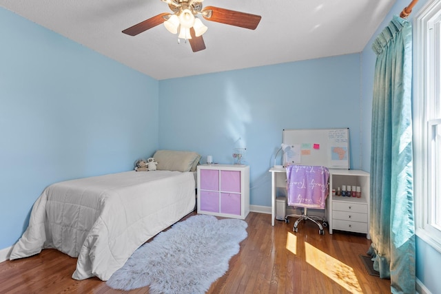 bedroom with ceiling fan and wood-type flooring