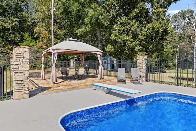 view of pool with a gazebo, a diving board, and a patio