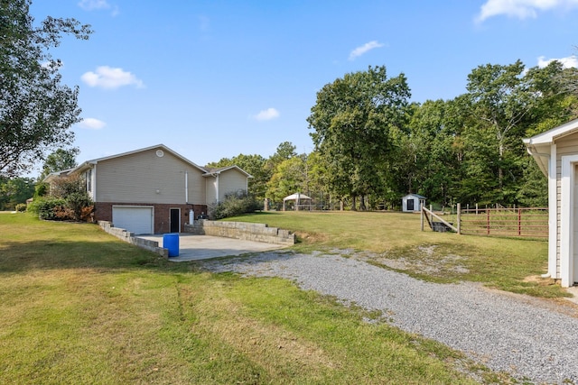 view of yard featuring a garage and a shed