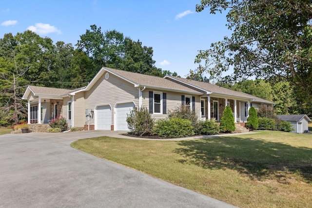 ranch-style house with a garage, a front lawn, and covered porch