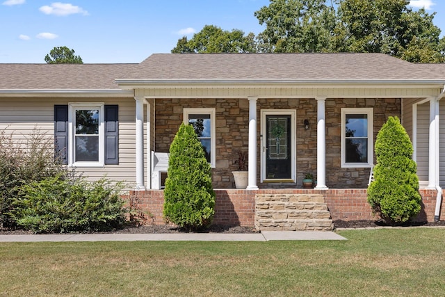 single story home featuring a porch and a front yard