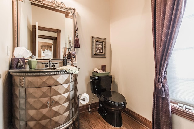 bathroom with vanity, hardwood / wood-style flooring, and toilet