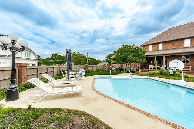 view of swimming pool featuring a patio area