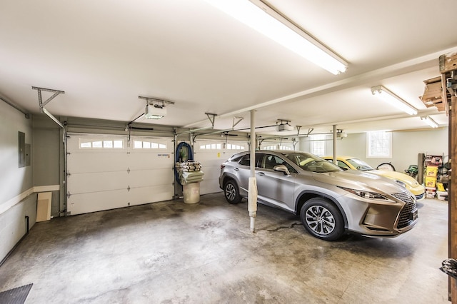 garage featuring a garage door opener and electric panel