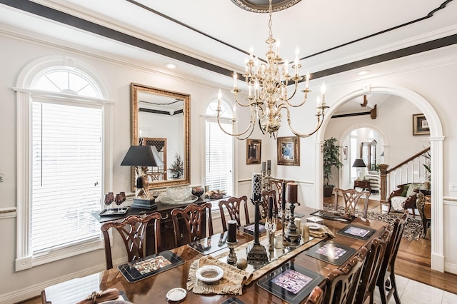 dining area with ornamental molding, a chandelier, and light wood-type flooring