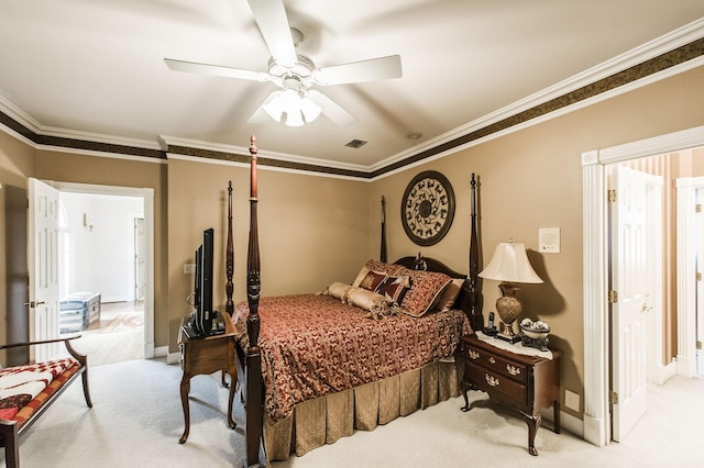 carpeted bedroom with ceiling fan and ornamental molding