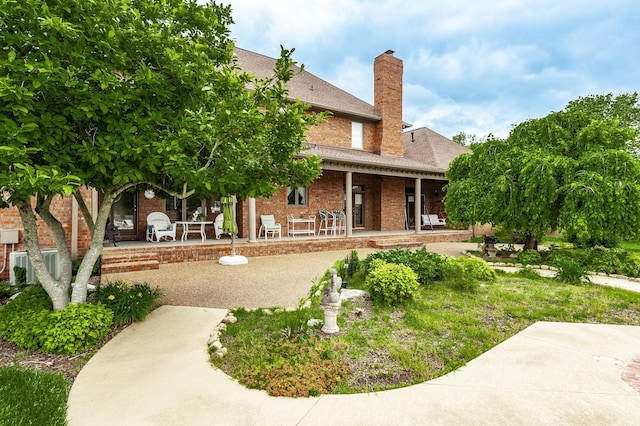 back of property featuring a porch and a patio