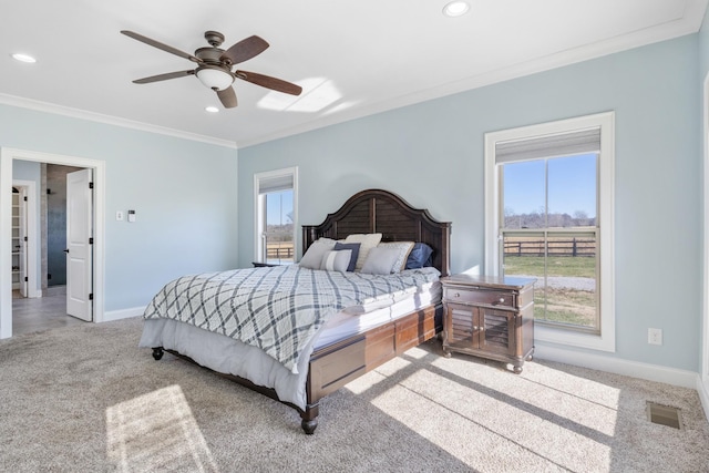 carpeted bedroom with ornamental molding and ceiling fan