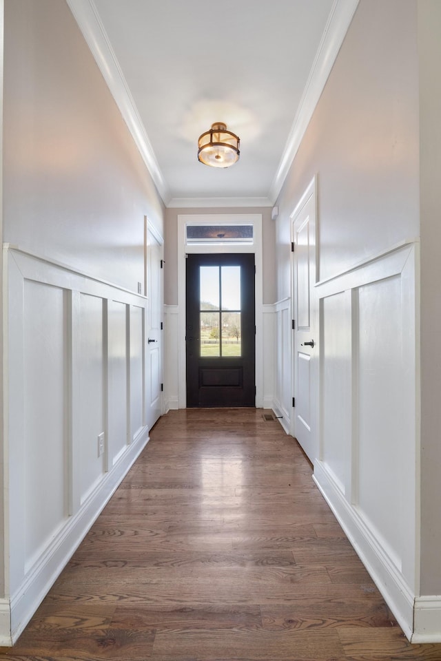 entryway featuring dark hardwood / wood-style flooring and ornamental molding