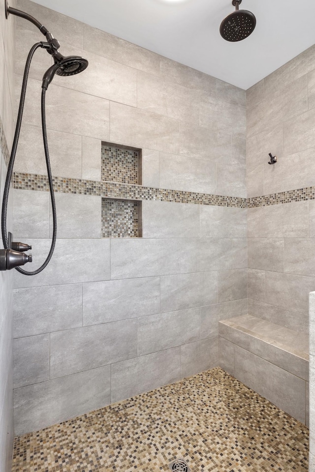 bathroom featuring a tile shower