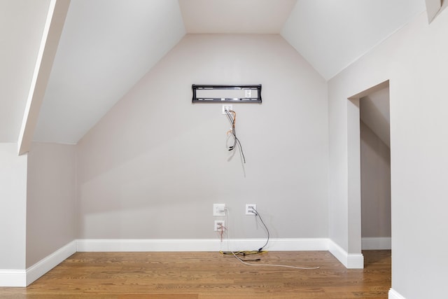 additional living space featuring lofted ceiling and hardwood / wood-style floors