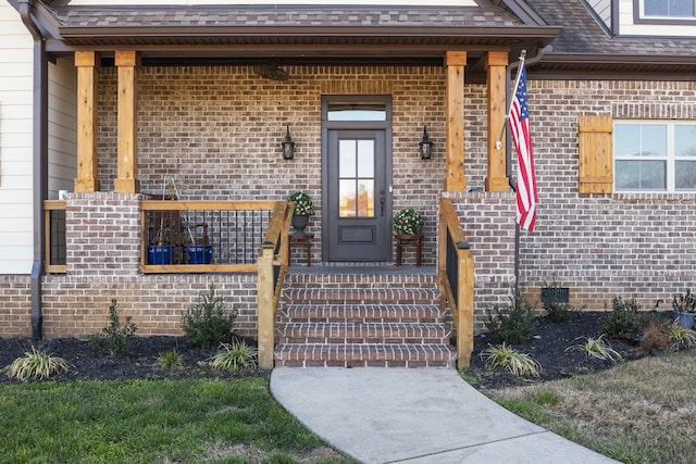 view of exterior entry featuring covered porch