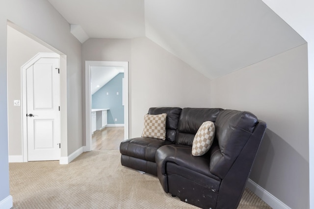 living area featuring light colored carpet and vaulted ceiling