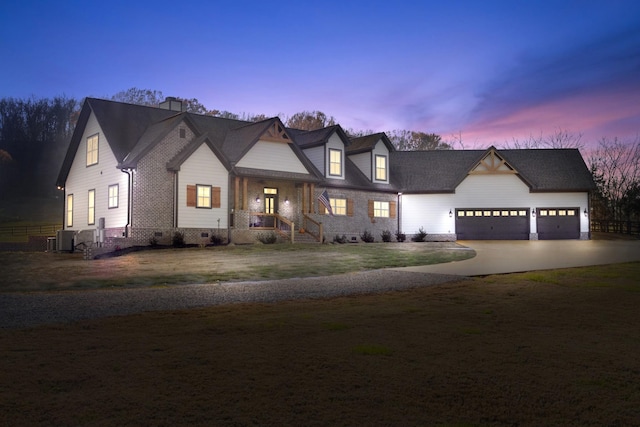 view of front of house with a yard and a garage