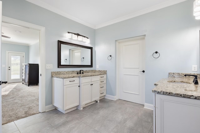 bathroom featuring tile patterned flooring, ornamental molding, and vanity