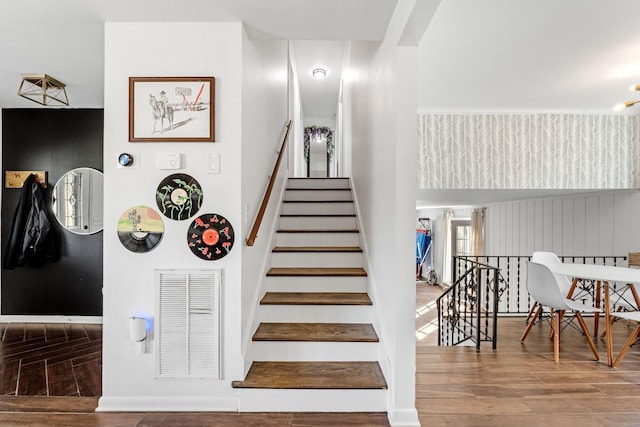 stairs featuring hardwood / wood-style floors