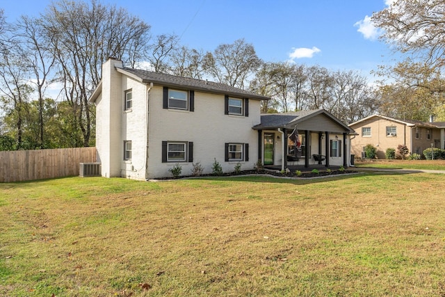 view of front of property featuring cooling unit and a front lawn