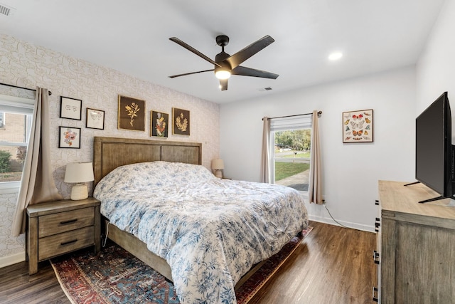 bedroom with dark hardwood / wood-style floors and ceiling fan