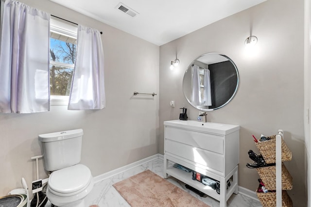 bathroom featuring vanity and toilet