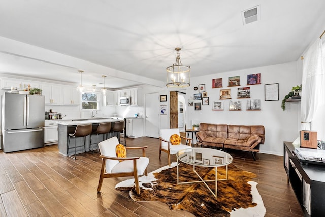 living room featuring light hardwood / wood-style flooring and a chandelier