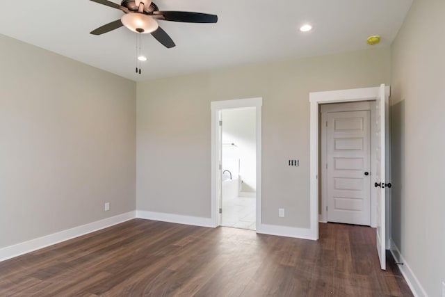 unfurnished bedroom with dark wood-style flooring, baseboards, recessed lighting, and ensuite bath