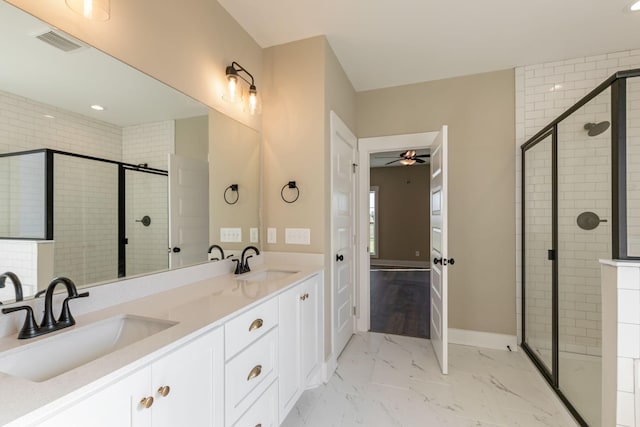 bathroom with a shower stall, visible vents, a sink, and ceiling fan