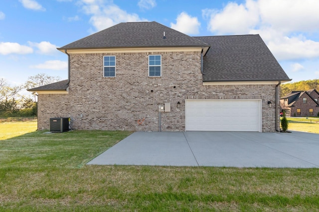view of side of property featuring central AC, a lawn, brick siding, a shingled roof, and driveway