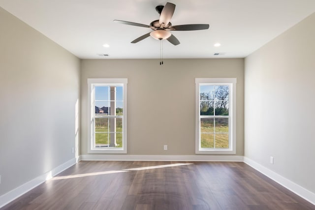 unfurnished room featuring dark wood-type flooring, a ceiling fan, visible vents, recessed lighting, and baseboards