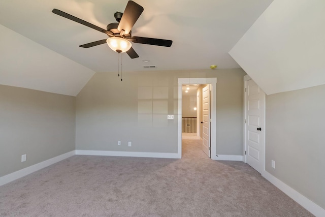 additional living space with visible vents, ceiling fan, vaulted ceiling, and carpet floors