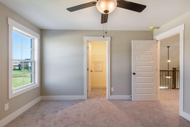 unfurnished bedroom with carpet flooring and baseboards