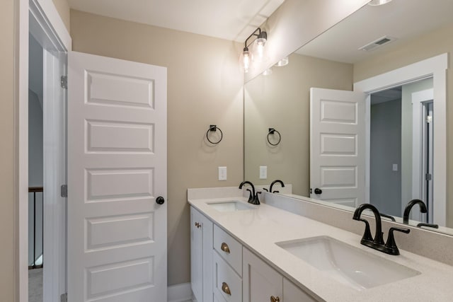 full bathroom with a sink, visible vents, and double vanity