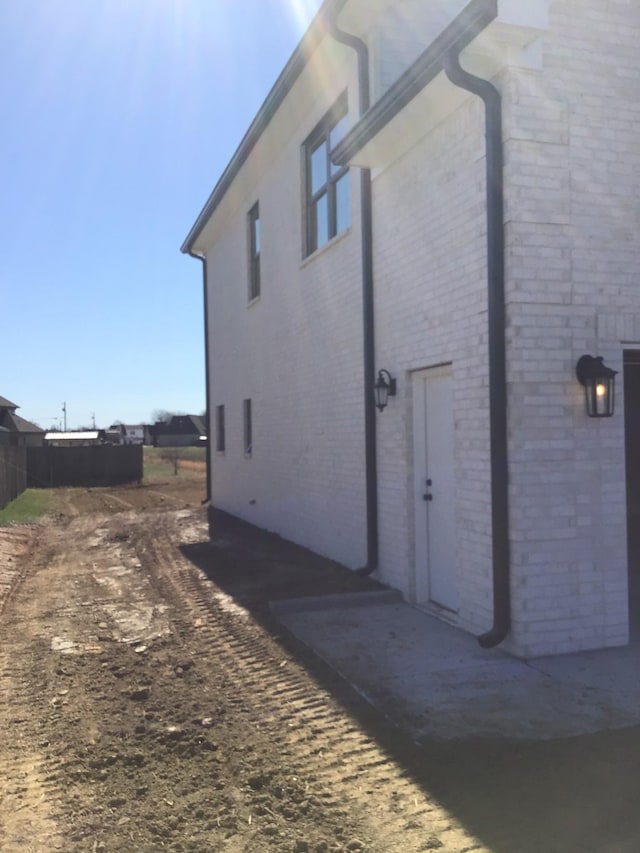 view of side of property featuring brick siding