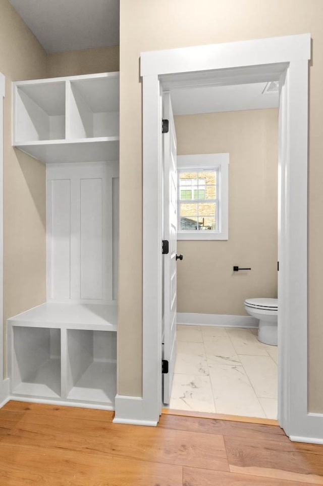 mudroom with marble finish floor, baseboards, and visible vents