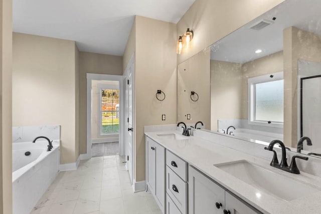 bathroom with a sink, baseboards, double vanity, and a bath