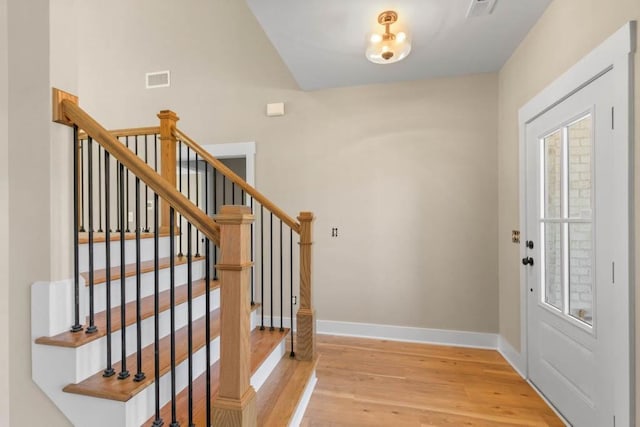 foyer featuring visible vents, baseboards, plenty of natural light, and light wood-style floors