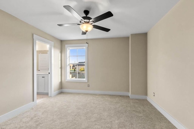unfurnished room featuring light carpet, baseboards, and ceiling fan