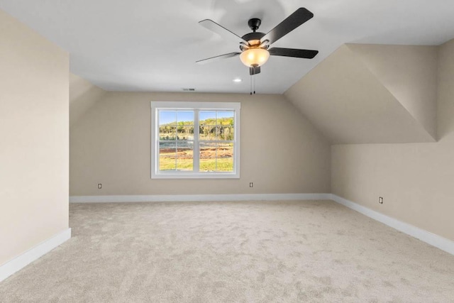 additional living space featuring carpet, baseboards, a ceiling fan, and lofted ceiling