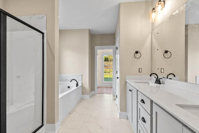 bathroom featuring baseboards, a shower stall, a bath, marble finish floor, and a sink